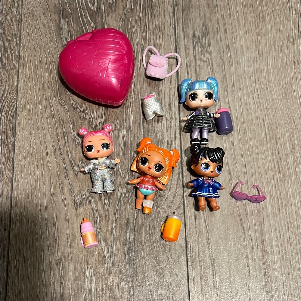 Lot of 4 lol dolls and accessories.